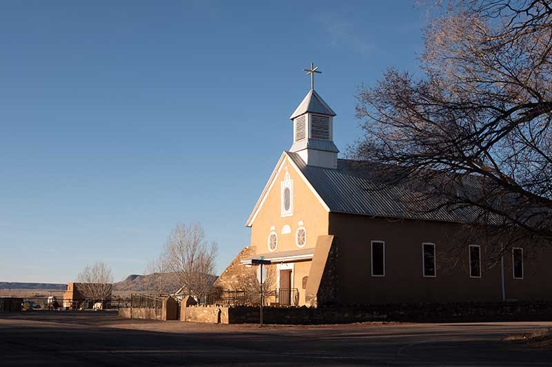 morning light on small Galisteo church